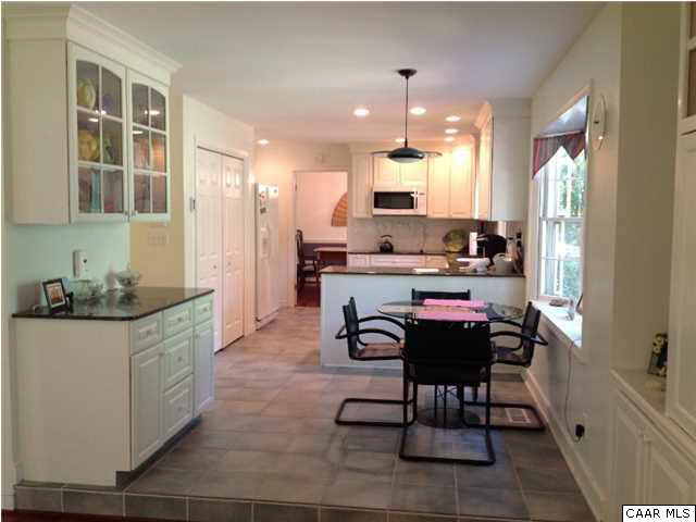 2803 Huntington Road Charlottesville, VA 22901 - Photo 14 of 42 a kitchen with kitchen island granite countertop a sink and a stove top oven