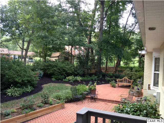 2803 Huntington Road Charlottesville, VA 22901 - Photo 20 of 42 a view of a patio with table and chairs potted plants and large tree