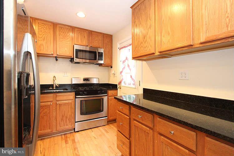 4403 Randolph Road Silver Spring, MD 20906 - Photo 8 of 28 a kitchen with stainless steel appliances granite countertop a stove a sink and a microwave