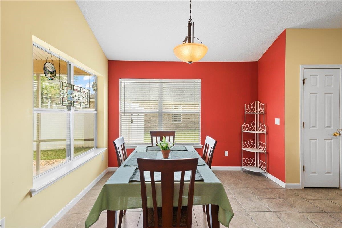 880 East Red House Branch Road St. Augustine, FL 32084 - Photo 14 of 65 a view of a dining room with furniture and a window