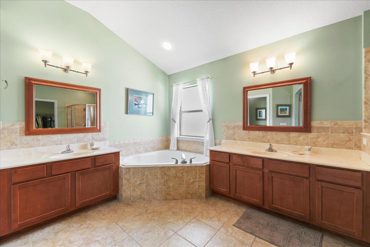 880 East Red House Branch Road St. Augustine, FL 32084 - Photo 20 of 65 a spacious bathroom with a tub sink and mirror