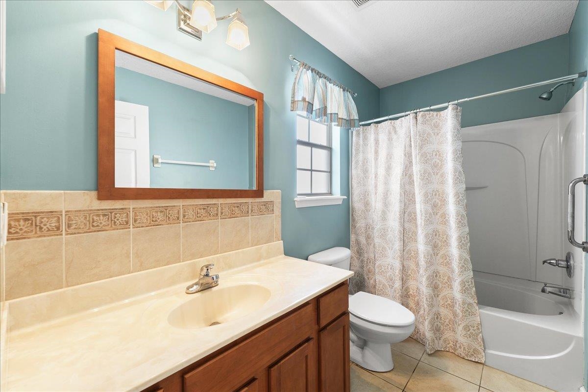 880 East Red House Branch Road St. Augustine, FL 32084 - Photo 26 of 65 a bathroom with a sink a toilet and shower