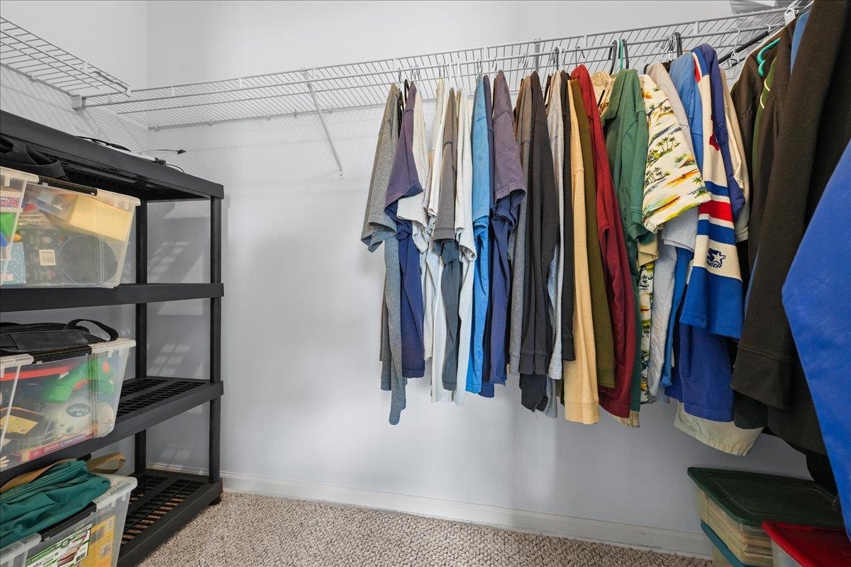 880 East Red House Branch Road St. Augustine, FL 32084 - Photo 30 of 65 a view of walk in closet with clothes and shoes
