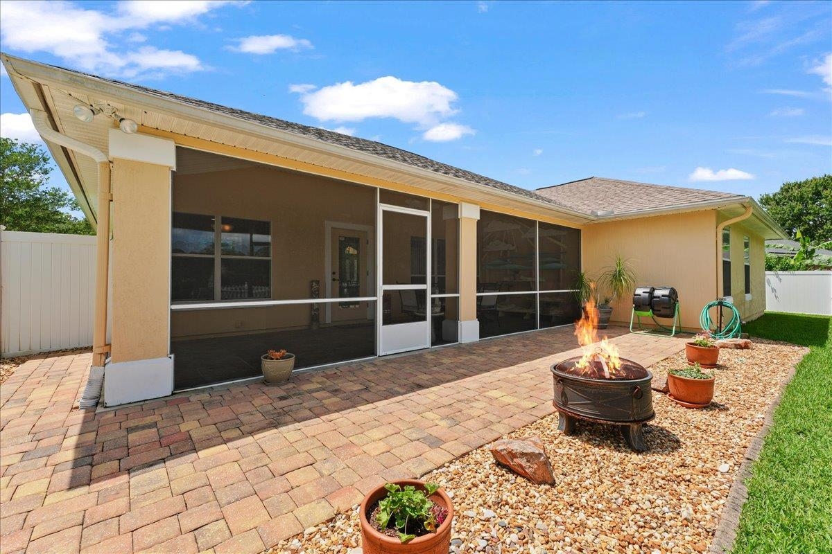 880 East Red House Branch Road St. Augustine, FL 32084 - Photo 34 of 65 a view of a patio with table and chairs potted plants