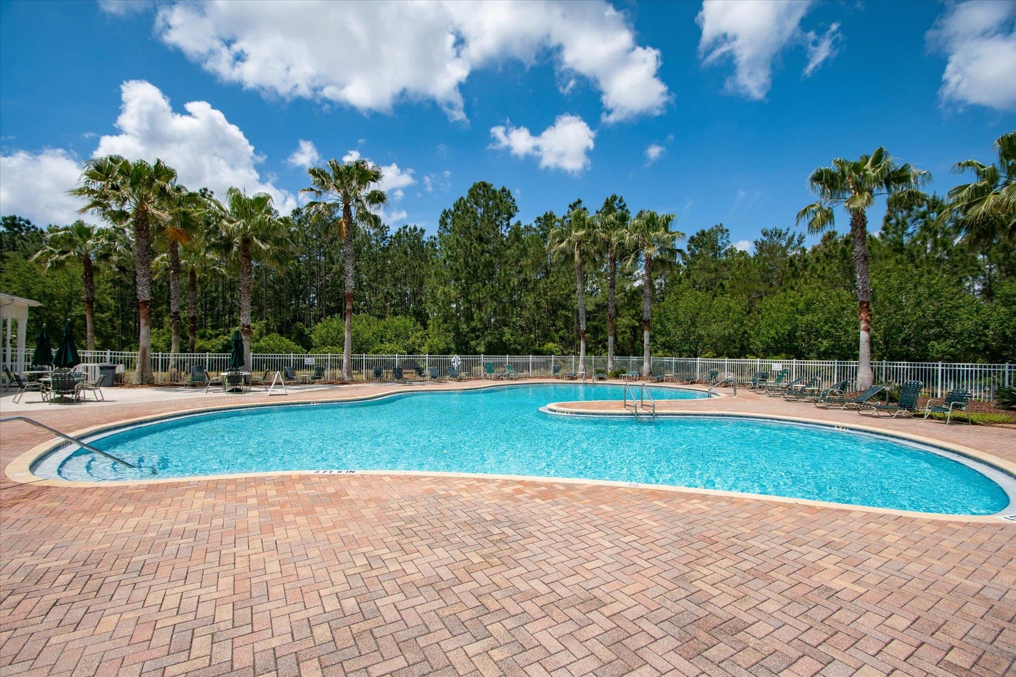 880 East Red House Branch Road St. Augustine, FL 32084 - Photo 55 of 65 a view of a swimming pool with an outdoor space and seating in back