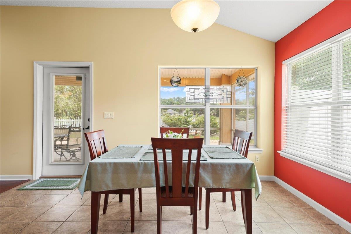 880 East Red House Branch Road St. Augustine, FL 32084 - Photo 6 of 65 a view of a dining room with furniture and wooden floor