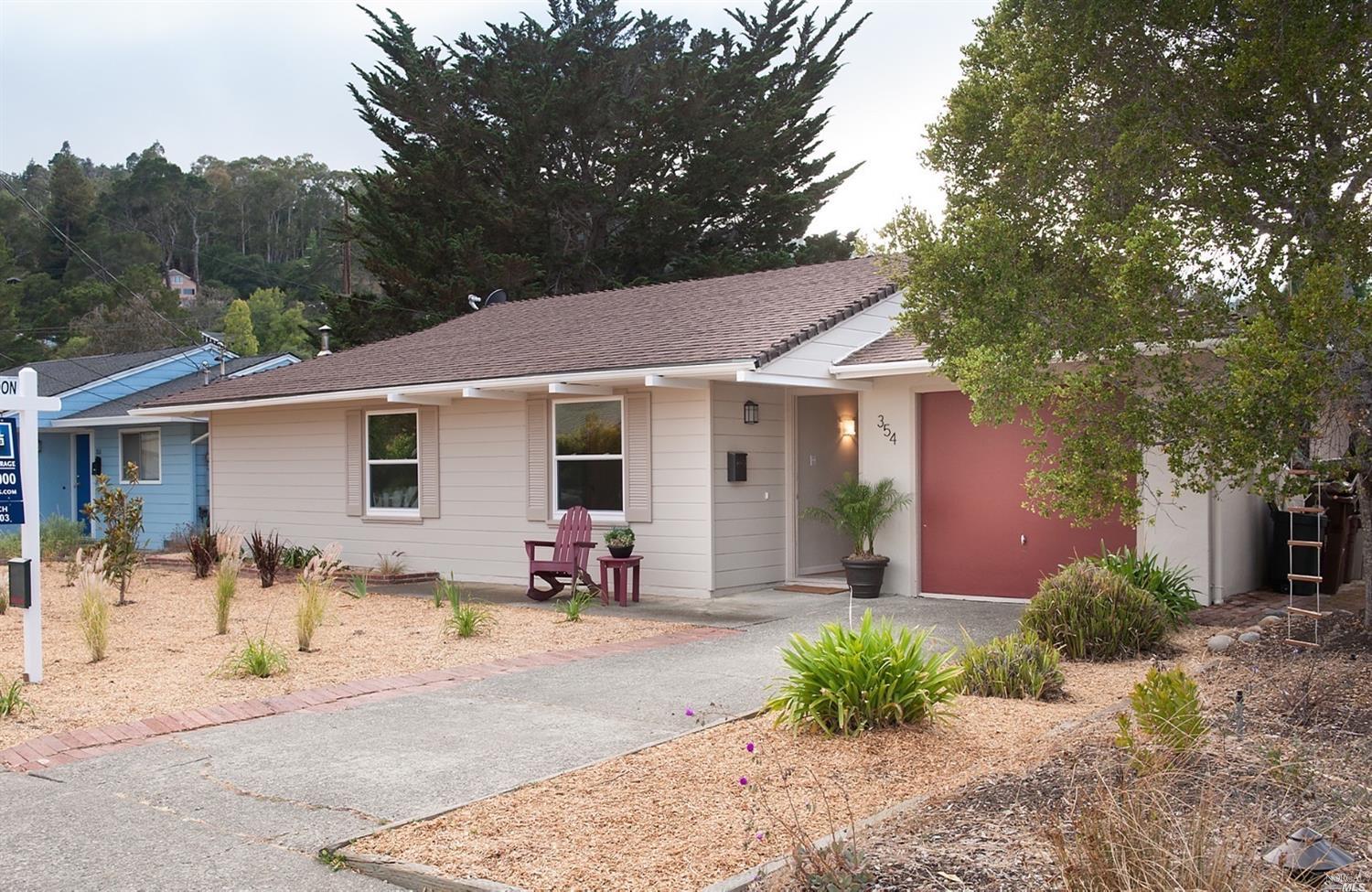 a front view of a house with yard and seating space