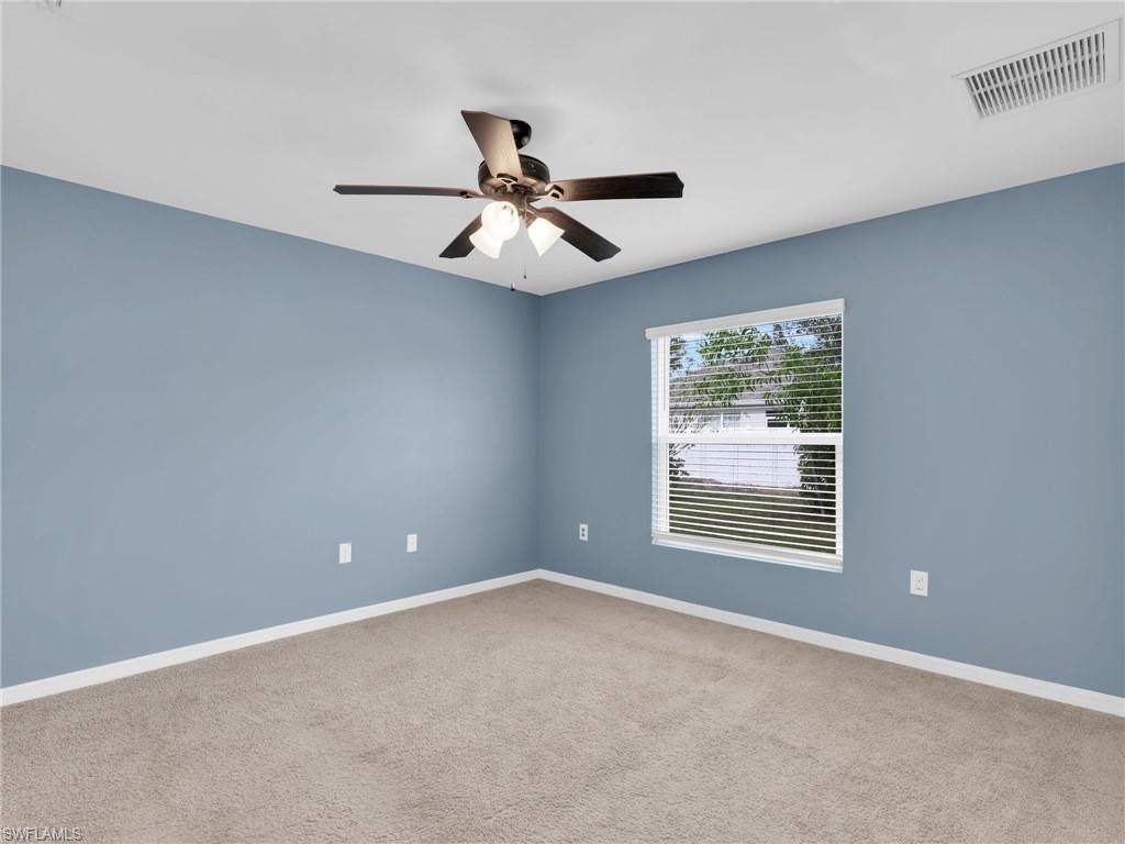 731 Hadley Place West Naples, FL 34104 - Photo 20 of 30 Primary Bedroom With Ceiling Fan And Faux Wood Blinds