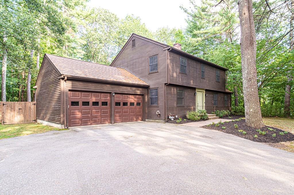 487 Boston Road Groton, MA 01450 - Photo 31 of 32 a front view of a house with a yard and garage