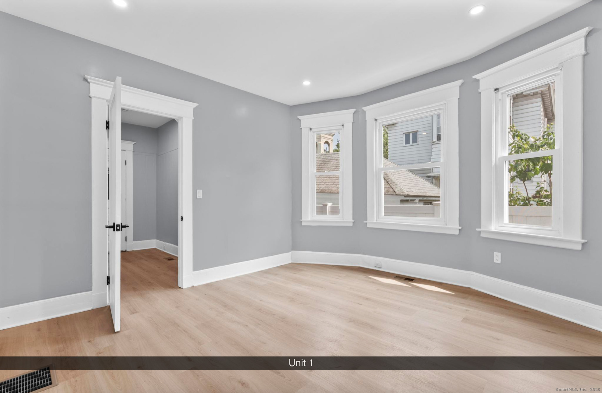 74 4th Street New Haven, CT 06519 - Photo 3 of 12 an empty room with wooden floor and windows