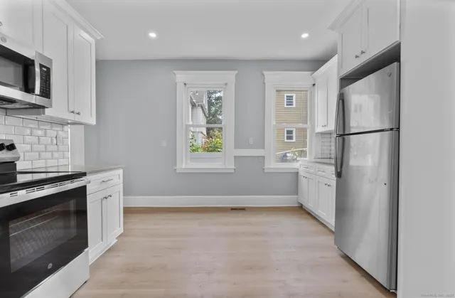 a kitchen with a refrigerator stove and microwave