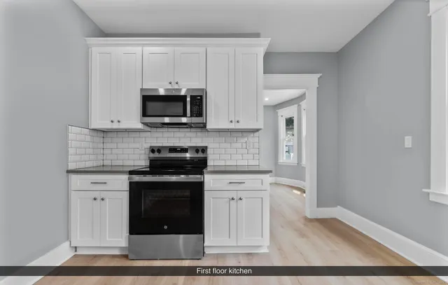 a kitchen with stainless steel appliances granite countertop a stove and a sink