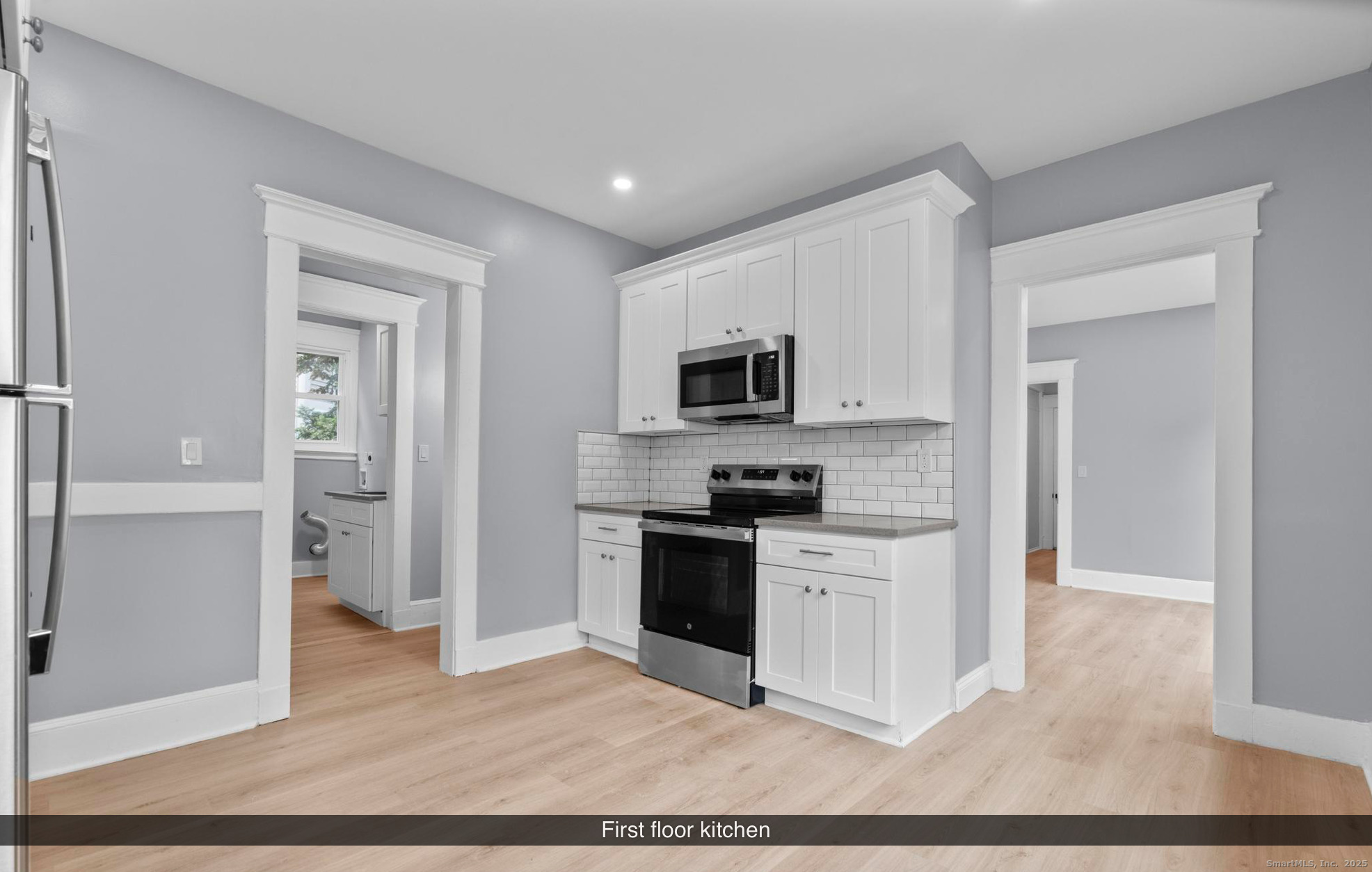 74 4th Street New Haven, CT 06519 - Photo 6 of 12 a kitchen with a refrigerator stove and white cabinets