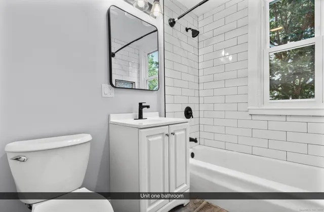 a bathroom with a toilet a sink and bathtub