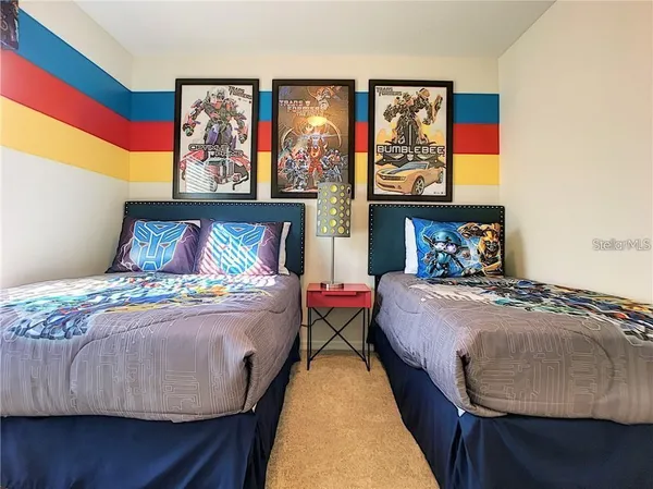 a bedroom with a bed and wall painting on the wall