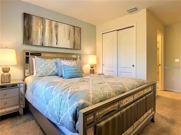 a bedroom with a bed and cabinets