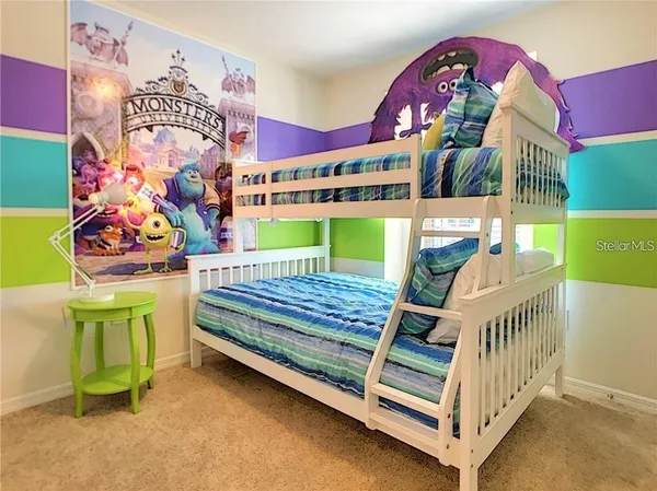 a bedroom with a bed and a wooden floor