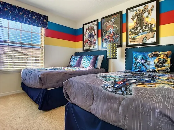 a bedroom with a bed and painting on the wall