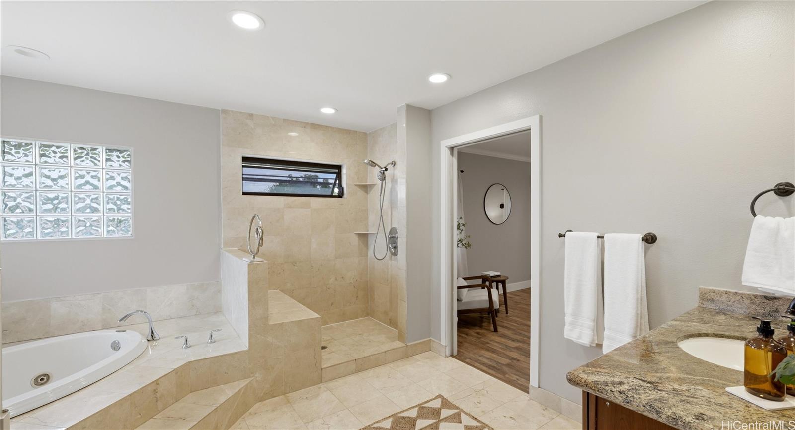 91-779 Fort Weaver Road Ewa Beach, HI 96706 - Photo 3 of 25 Luxury primary bath with a deep soaking tub, tiled walk-in shower with a built-in bench.