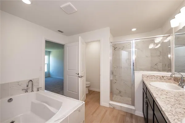 a bathroom with a sink and a mirror with shower