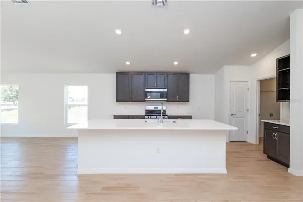 a kitchen with stainless steel appliances a sink stove and refrigerator