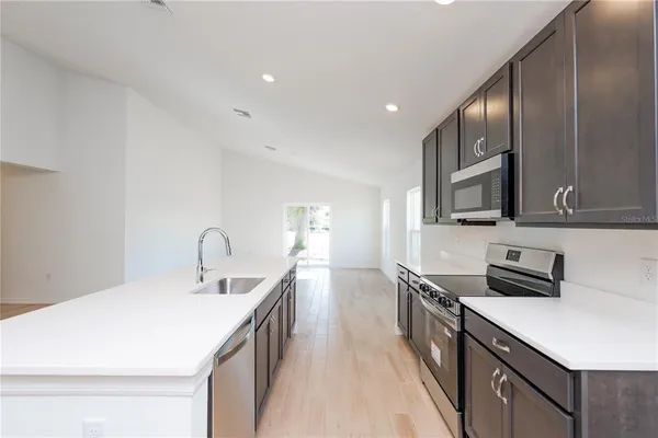 a kitchen with a sink stainless steel appliances and cabinets