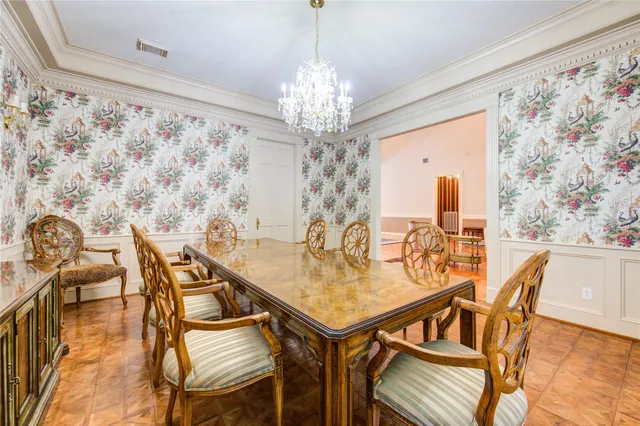 a view of a dining room with furniture and a chandelier