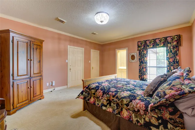 a bedroom with a bed next to a window