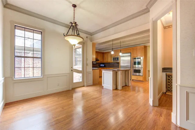 a view of a kitchen with a sink refrigerator and wooden floor