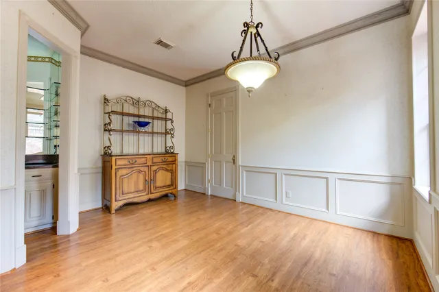 a view of a bedroom with cabinet and mirrors