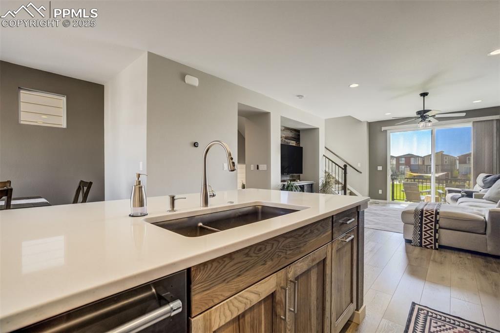 1325 Sunshine Vly Way Colorado Springs, CO 80921 - Photo 11 of 45 a kitchen with a sink a counter top space and living room view