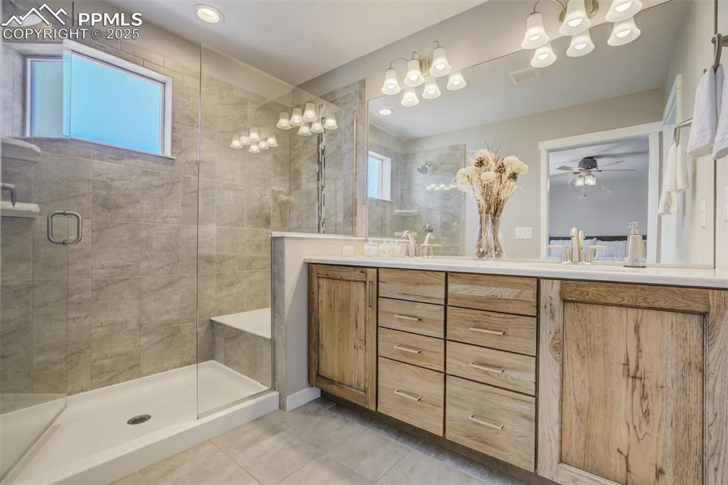 1325 Sunshine Vly Way Colorado Springs, CO 80921 - Photo 26 of 45 a bathroom with a sink mirror and a shower