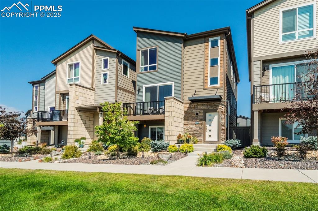 1325 Sunshine Vly Way Colorado Springs, CO 80921 - Photo 40 of 45 a front view of a house with a yard and porch