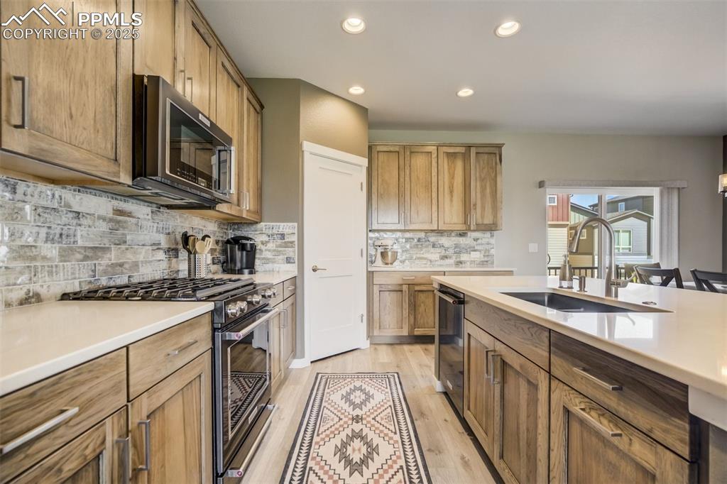1325 Sunshine Vly Way Colorado Springs, CO 80921 - Photo 4 of 45 a kitchen with stainless steel appliances granite countertop a sink stove microwave and cabinets