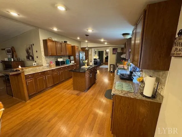 a kitchen with stainless steel appliances granite countertop sink stove top oven and cabinets
