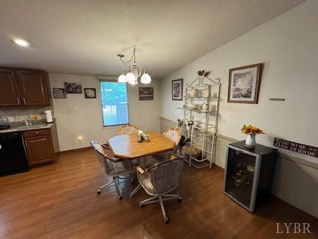 a room with table chairs and wooden floor