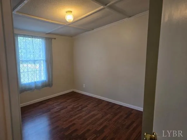 a view of a room with wooden floor and windows