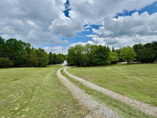 a view of a backyard with a patio and fire pit