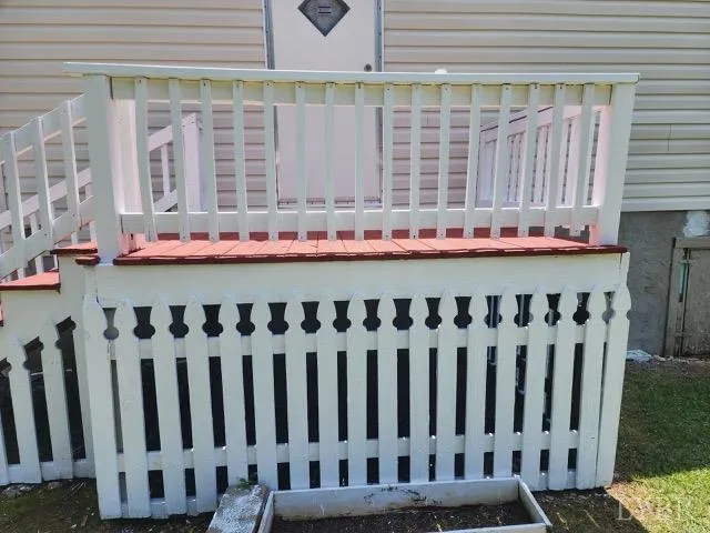 a view of a yard with wooden deck