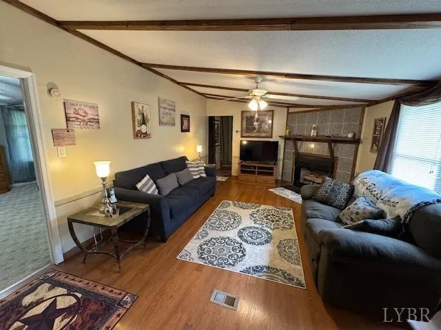 a living room with furniture and a fireplace