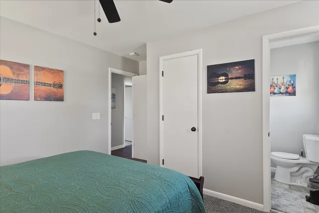 a bedroom with a bed and a view of bathroom