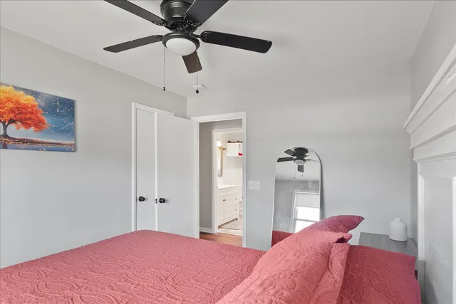 a bedroom with a bed and a painting on the wall