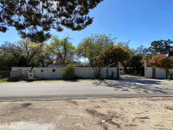 a street view of a house with a yard