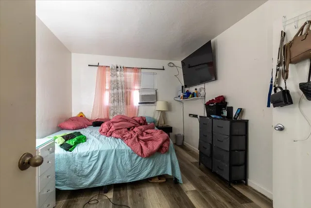 a bedroom with a bed closet and flat tv screen