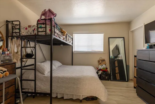 a bedroom with a bed next to a window