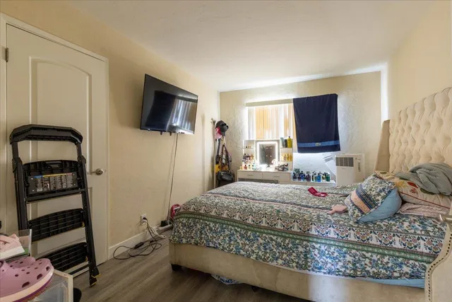 a bedroom with a bed and a flat screen tv