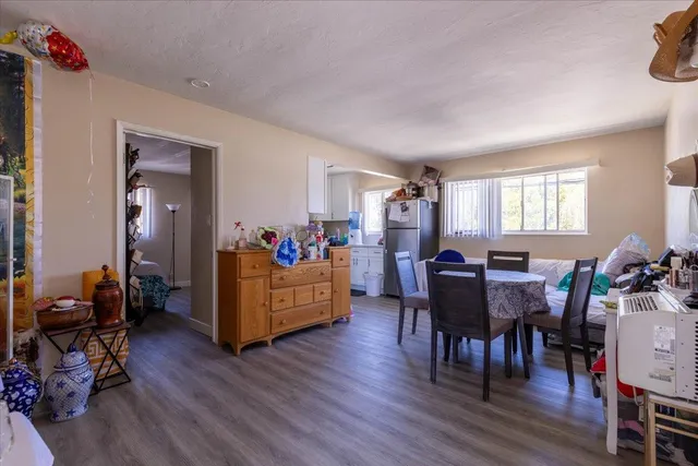 a living room with furniture dining room and wooden floor