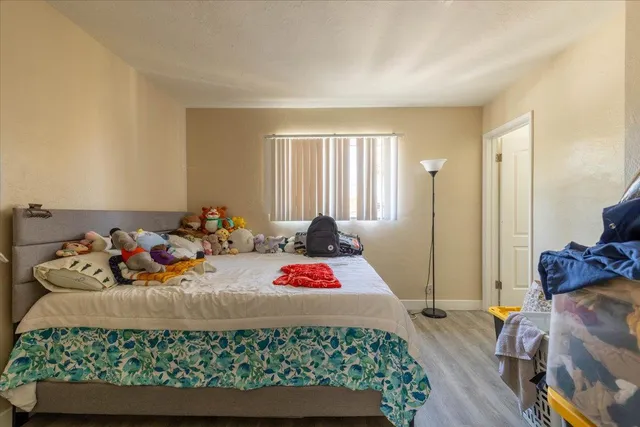 a bedroom with bed and a window