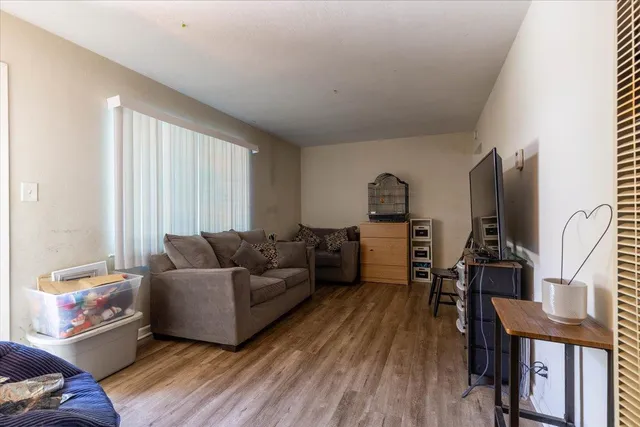 a living room with furniture and wooden floor