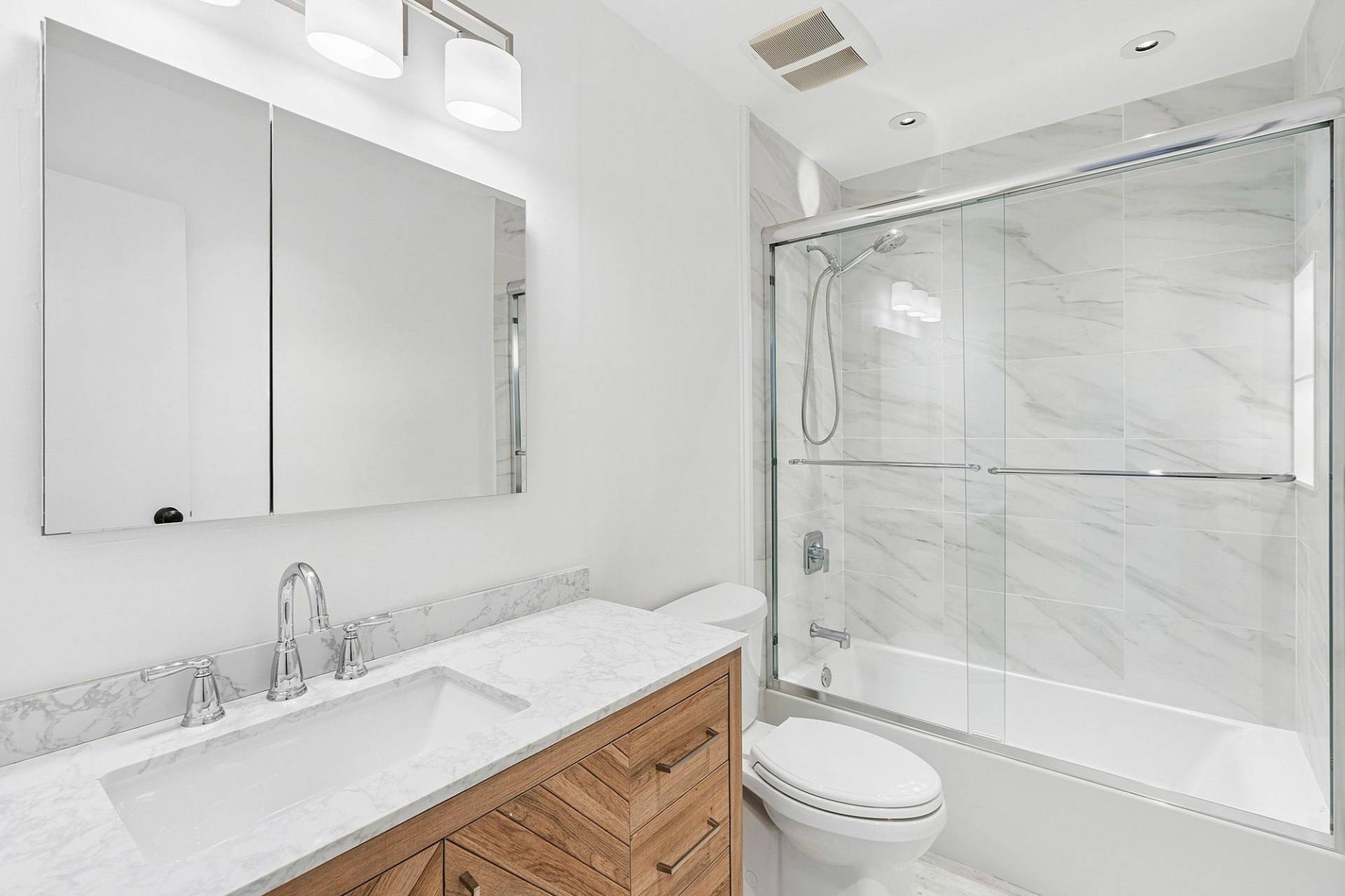3004 Mitchell Road Westhampton Beach, NY 11978 - Photo 11 of 24 a bathroom with a granite countertop sink toilet and shower